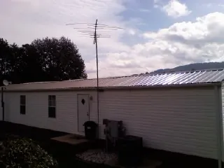 New metal roof on a single wide mobile home with a TV antenna in Kittitas